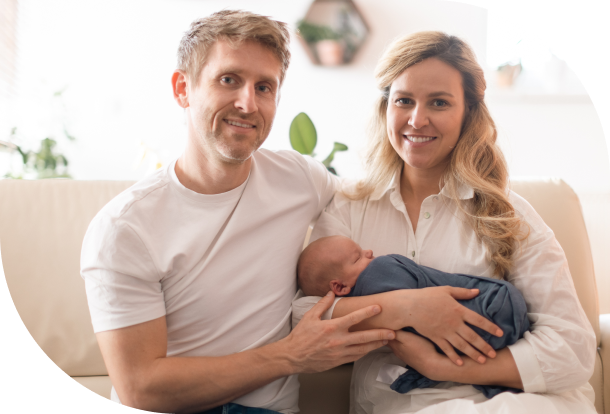Baby being held by couple.